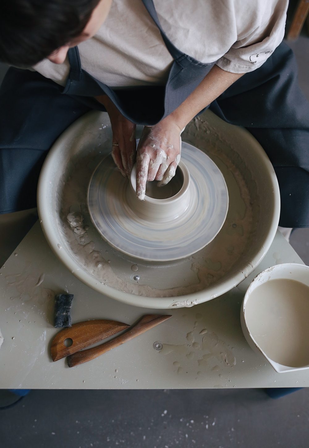 working-on-a-potter-s-wheel-with-a-clay-in-a-pottery-studio-clay-jug.jpg